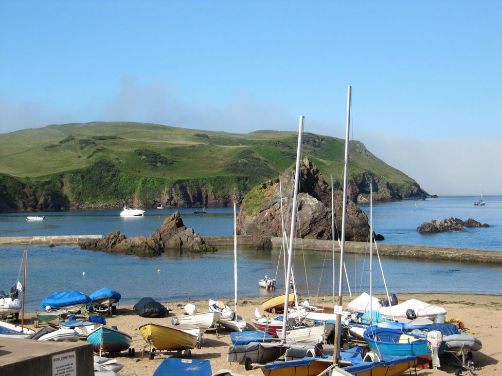 Boats on the shore with hills and water at Hope Cove near Kingsbridge