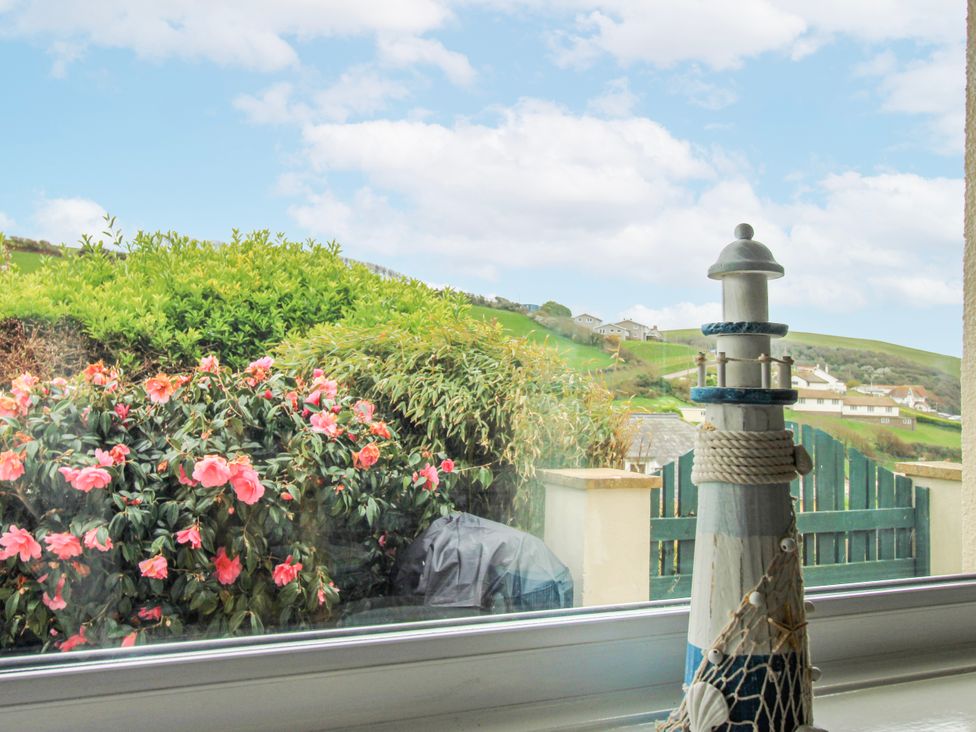 A lighthouse decoration and flowers at Quay Sands, Hope Cove