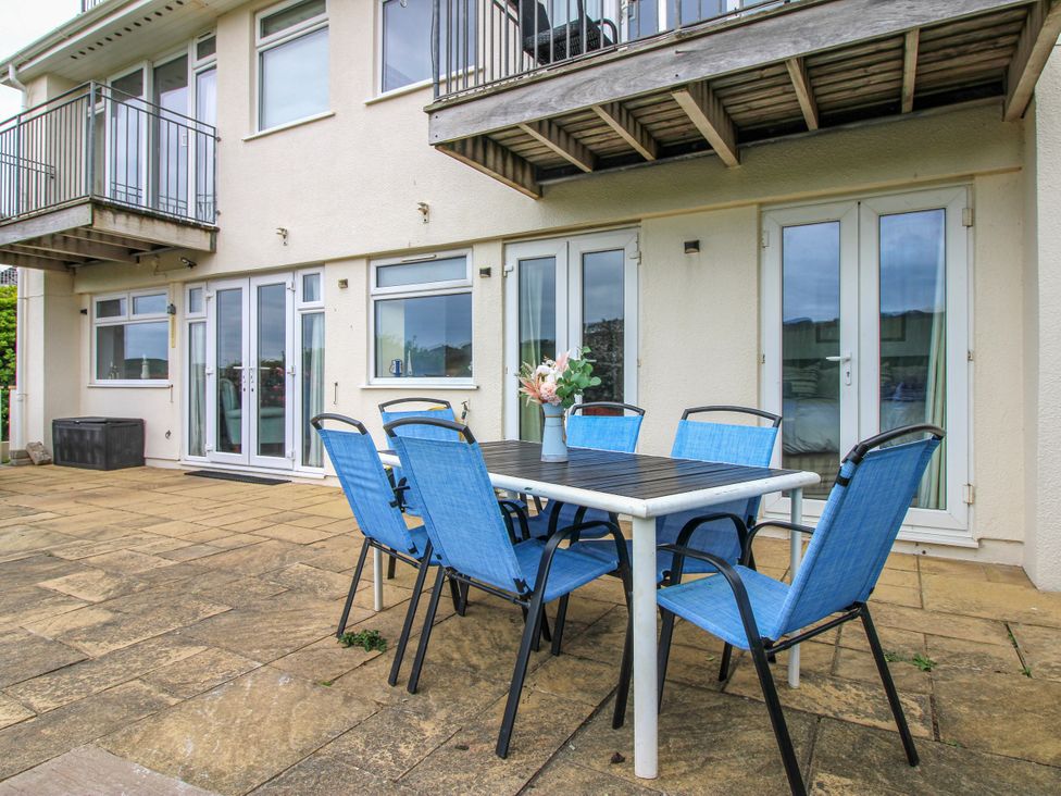 An outdoor patio with a table and chairs at Quay Sands, Hope Cove