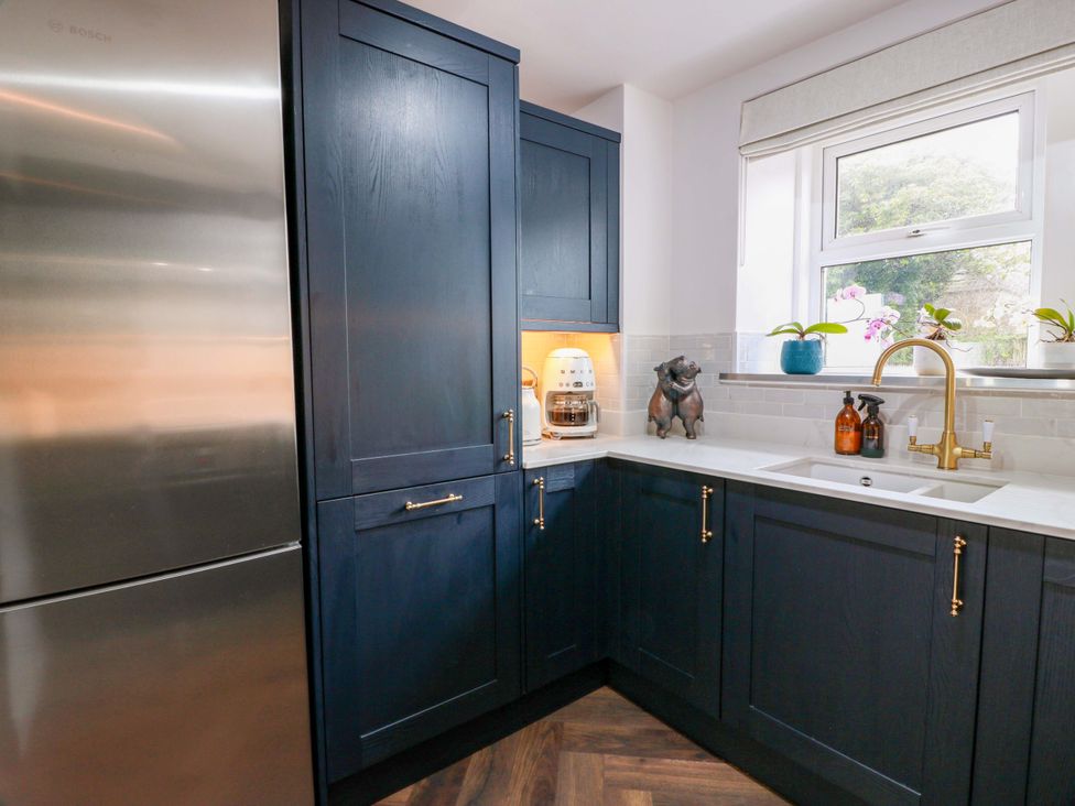 A kitchen with cabinets, sink, and appliances at 7 Brewery Pool in Newton Stewart
