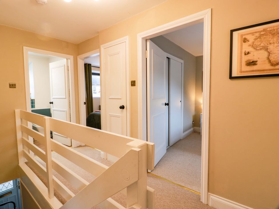 A hallway with doors and a handrail at 7 Brewery Pool in Newton Stewart