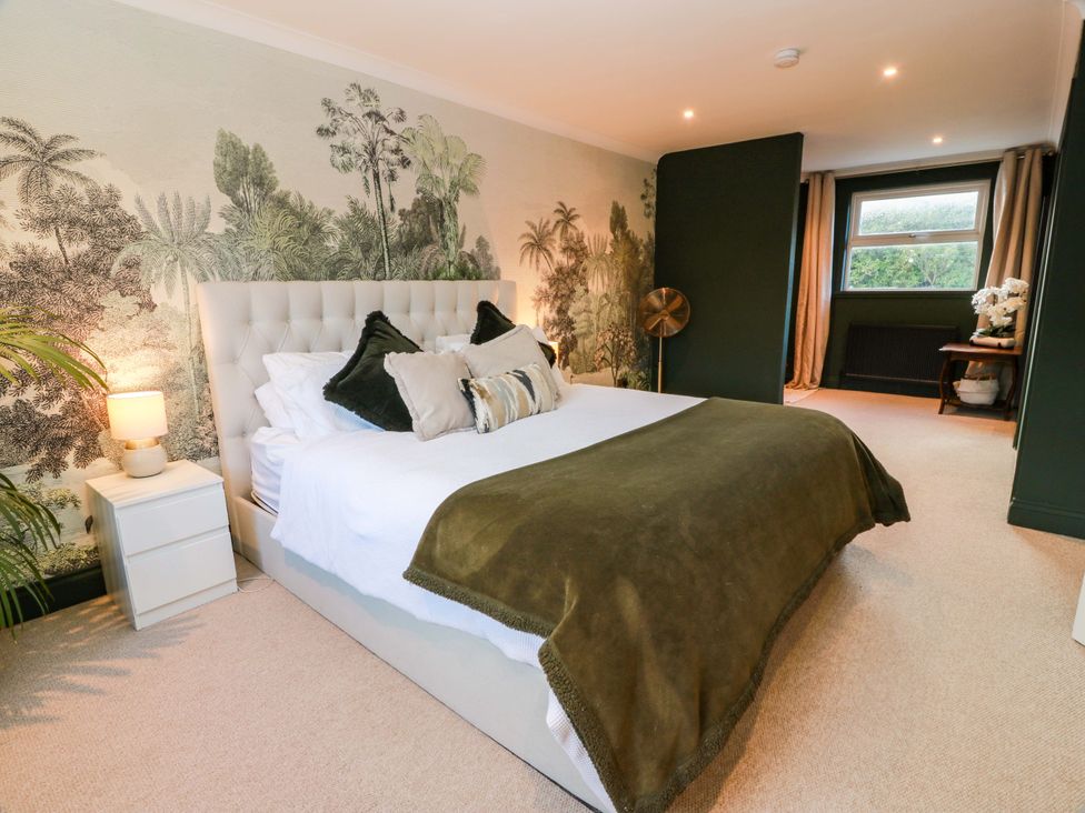 A bedroom with a bed and bedside table at 7 Brewery Pool in Newton Stewart
