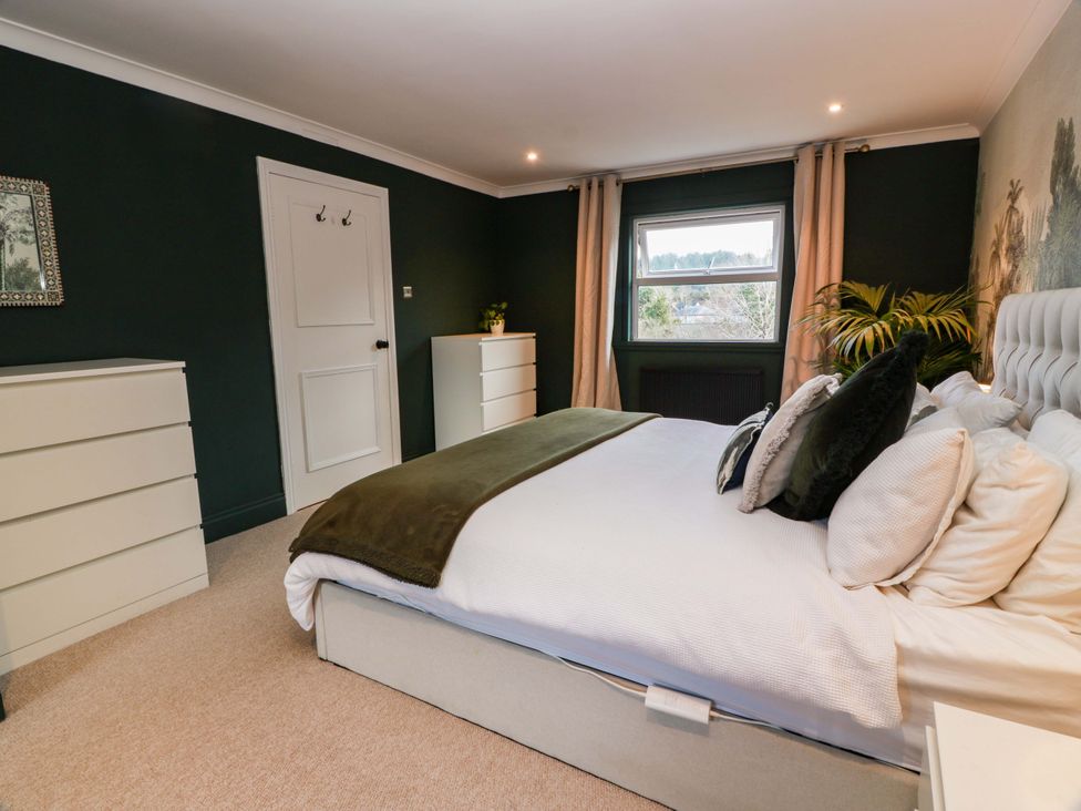 A bedroom with a bed and furniture at 7 Brewery Pool in Newton Stewart