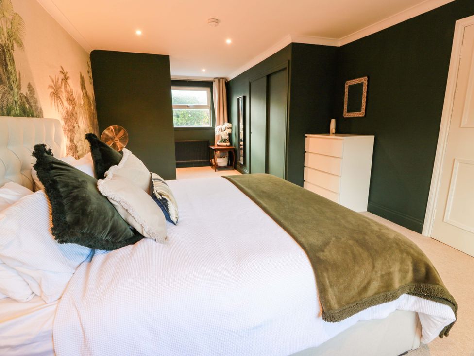 A bedroom with a bed and dresser at 7 Brewery Pool in Newton Stewart