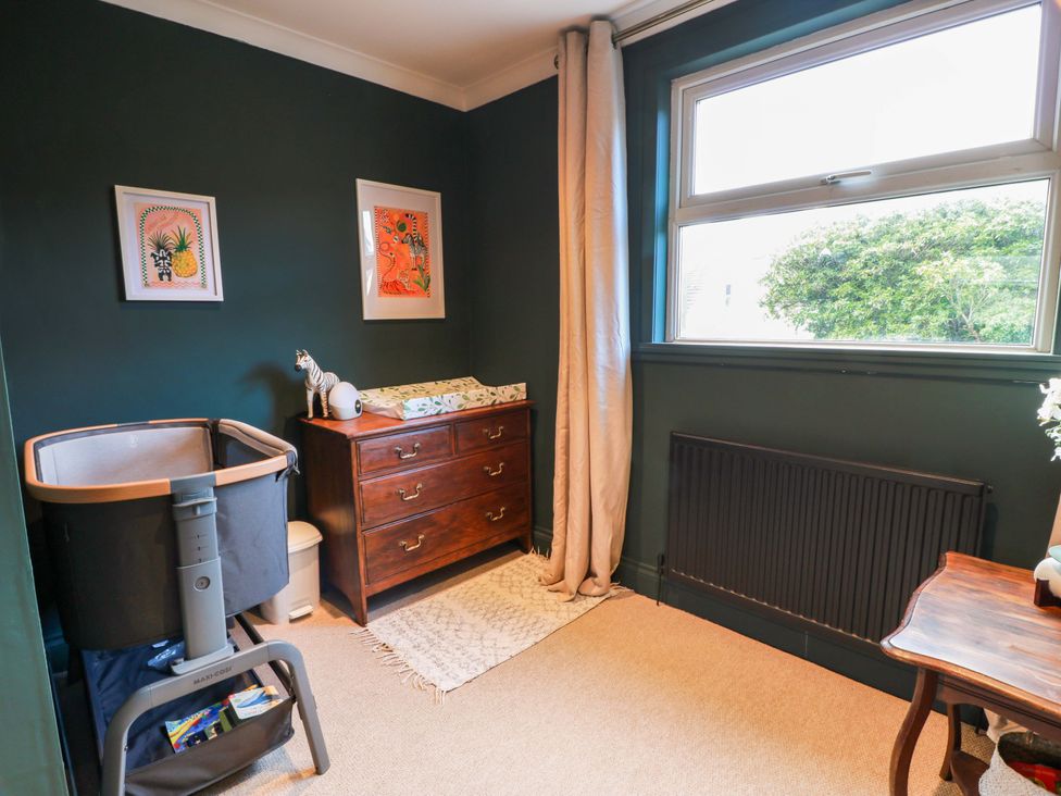 A nursery with a bassinet and dresser at 7 Brewery Pool in Newton Stewart