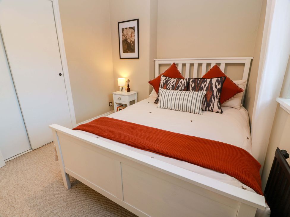 A bedroom with a bed and bedside table at 7 Brewery Pool in Newton Stewart