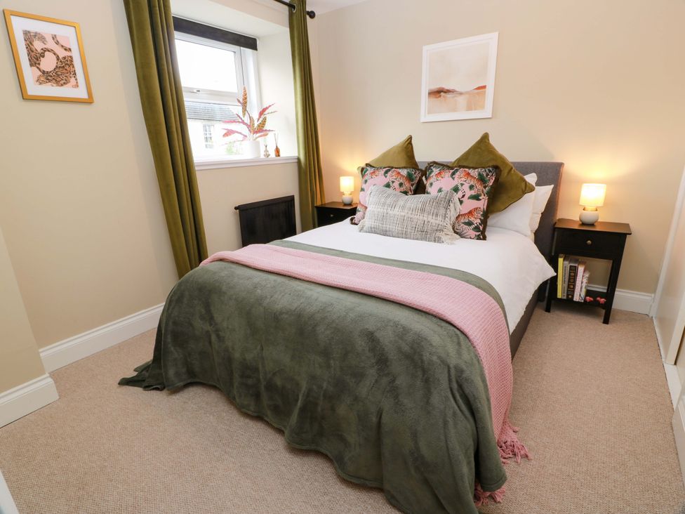 A bedroom with a bed and bedside tables at 7 Brewery Pool in Newton Stewart