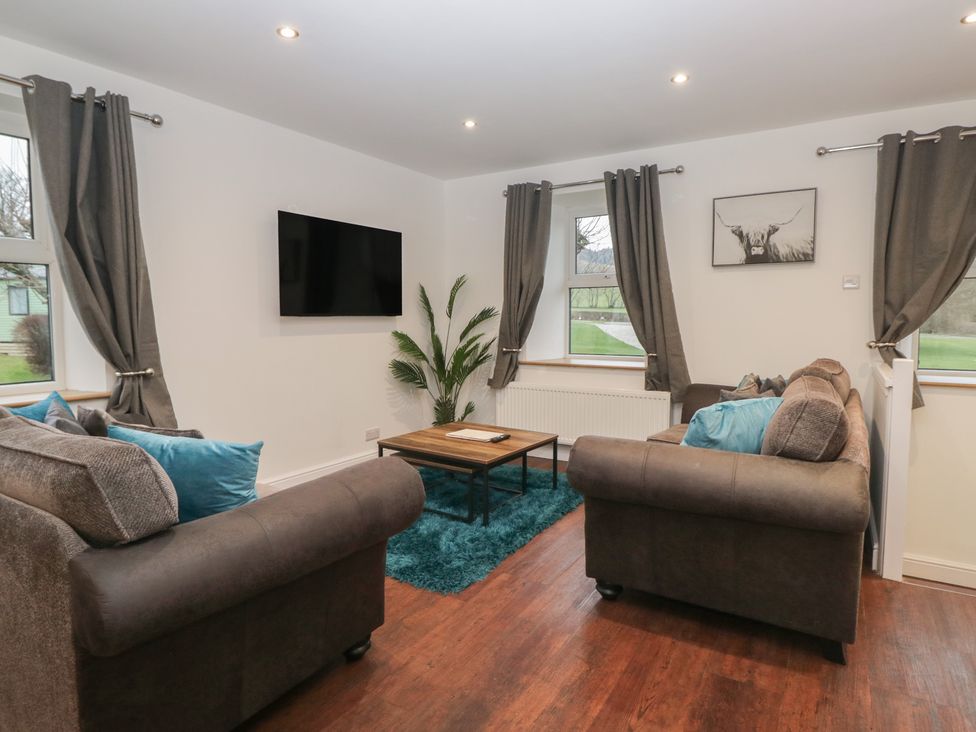 A living room with a television and seating arrangements at 6 Hallin Fell in Penrith