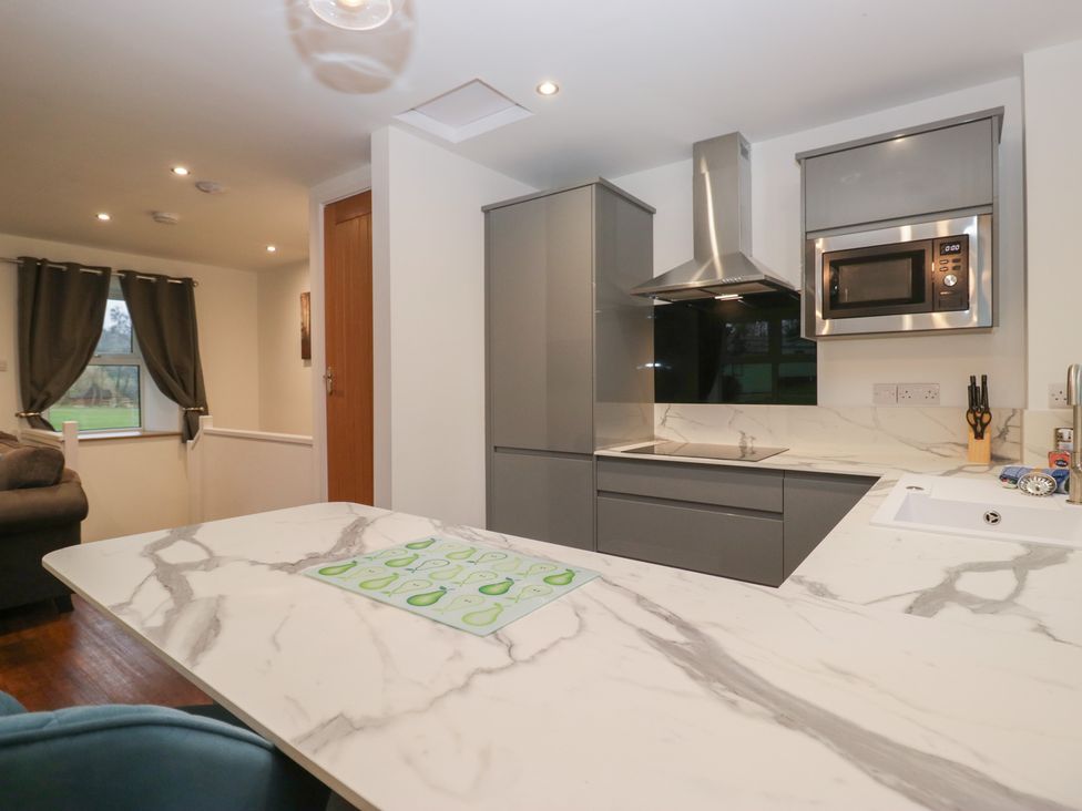 A kitchen with modern appliances and a marble countertop at 6 Hallin Fell in Penrith