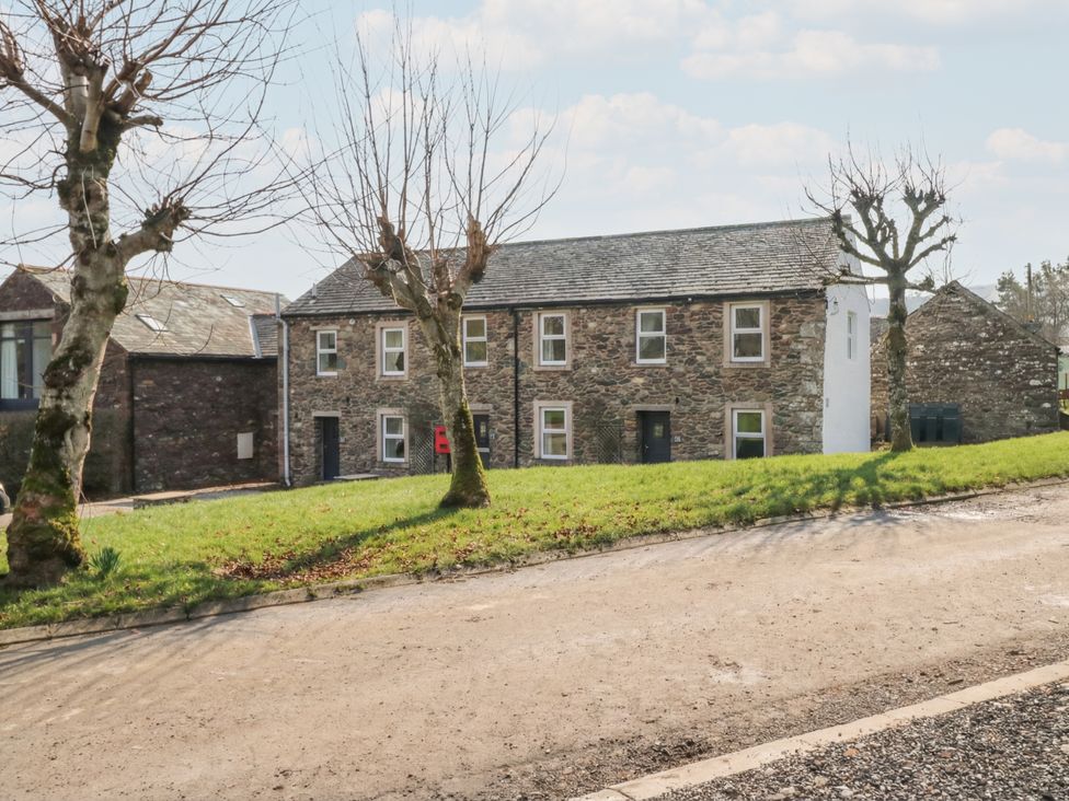 A house with trees and grass in front at 6 Hallin Fell in Penrith