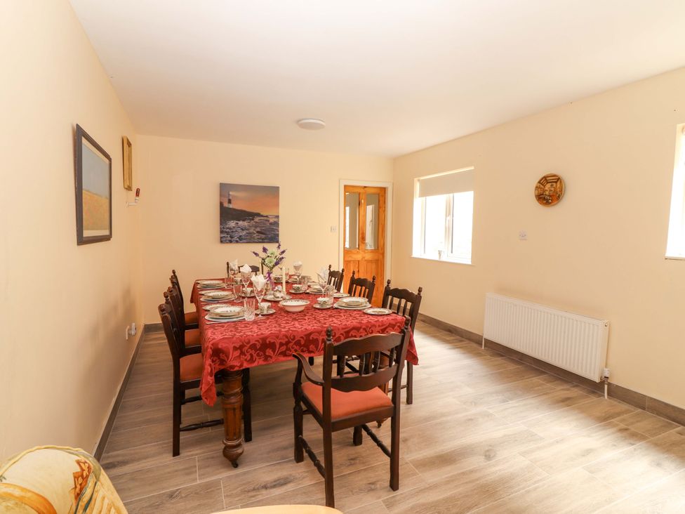 A dining room with a table set for a meal at Macmathuna, Kilrush, County Clare