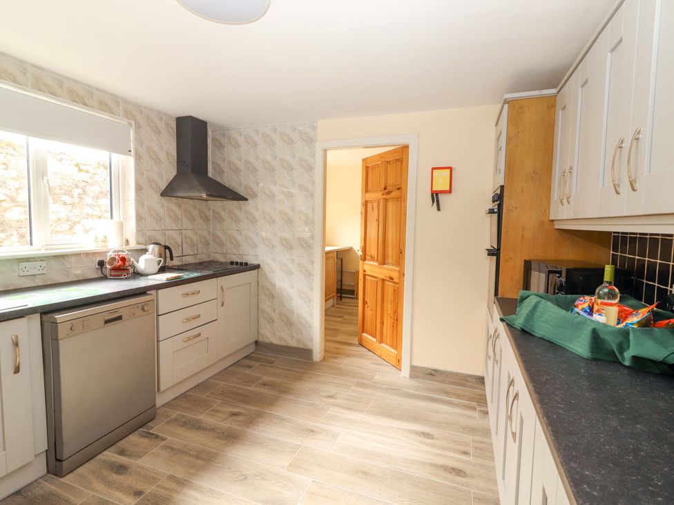 A kitchen with appliances and cabinets at Macmathuna in Kilrush, County Clare