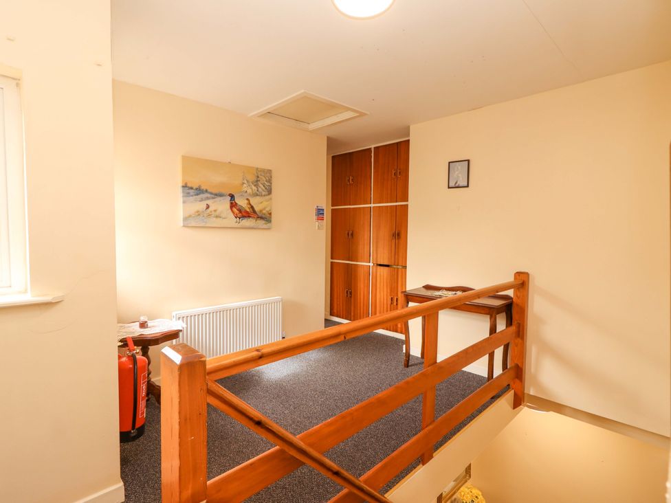 A hallway with a radiator and storage cabinet at Macmathuna in Kilrush, County Clare