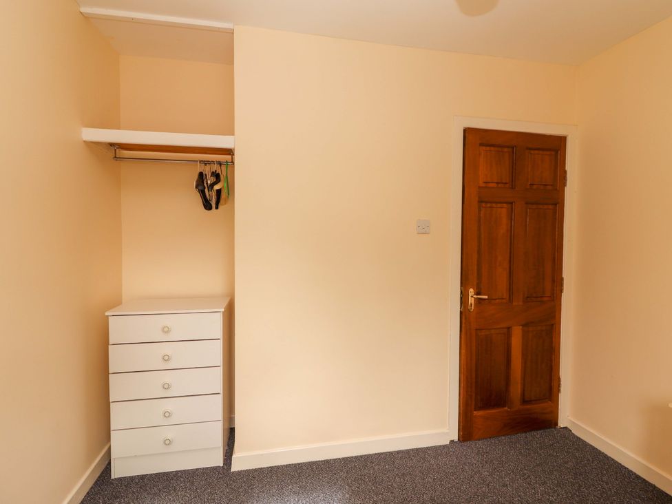 A bedroom with a closet and drawer unit at Macmathuna, Kilrush, County Clare