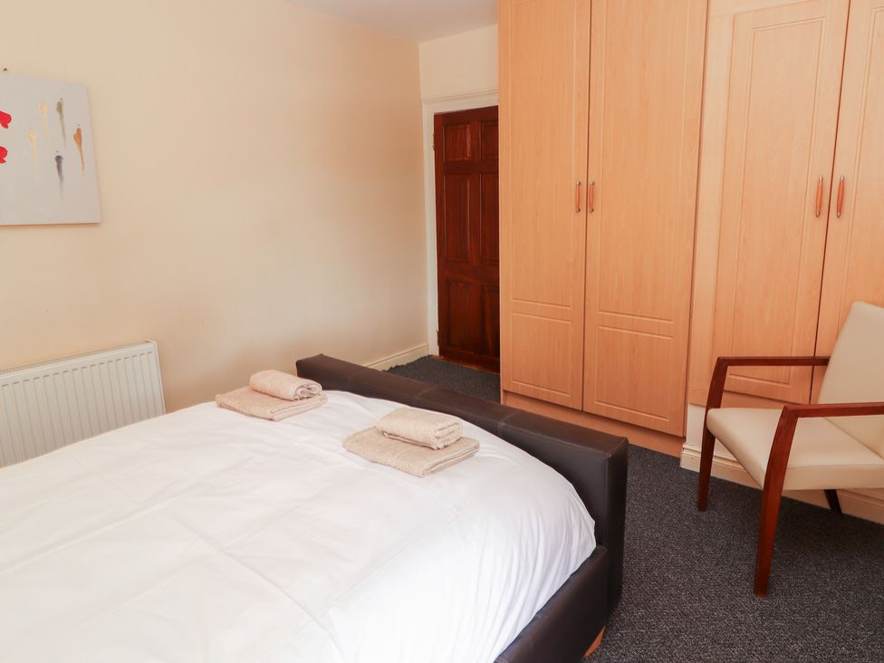 A bedroom with a bed and towels on it at Macmathuna in Kilrush, County Clare