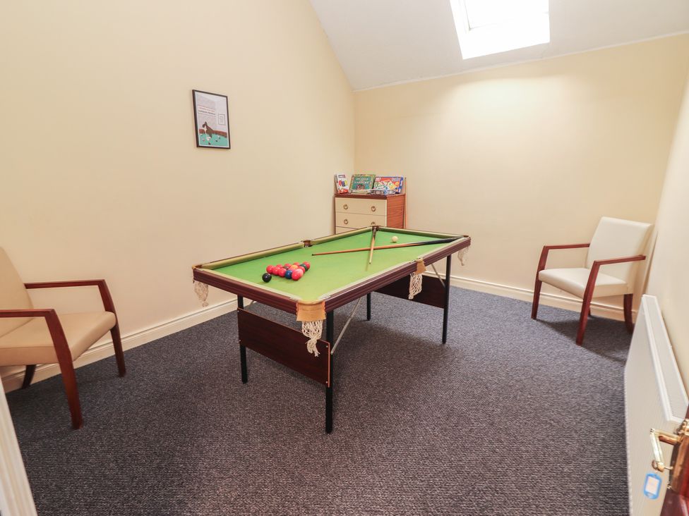 A snug with a snooker table and two chairs at Macmathuna in Kilrush, County Clare