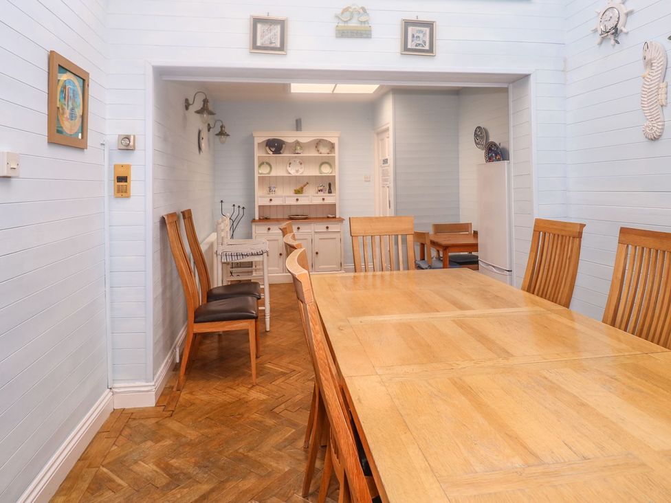A dining room featuring a wooden table and chairs at The Old Bank House Mevagissey