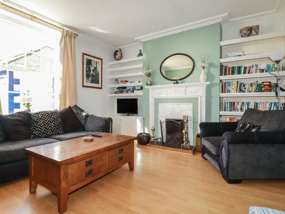 A living room with a sofa and coffee table at The Old Bank House in Mevagissey