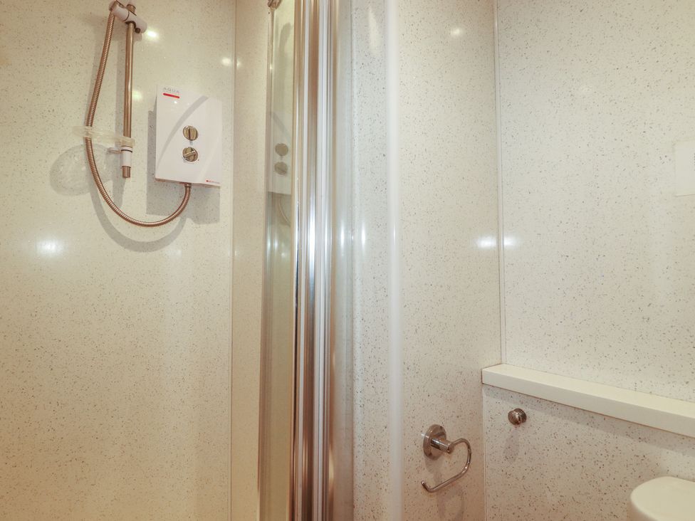 A bathroom with a shower unit at The Old Bank House in Mevagissey