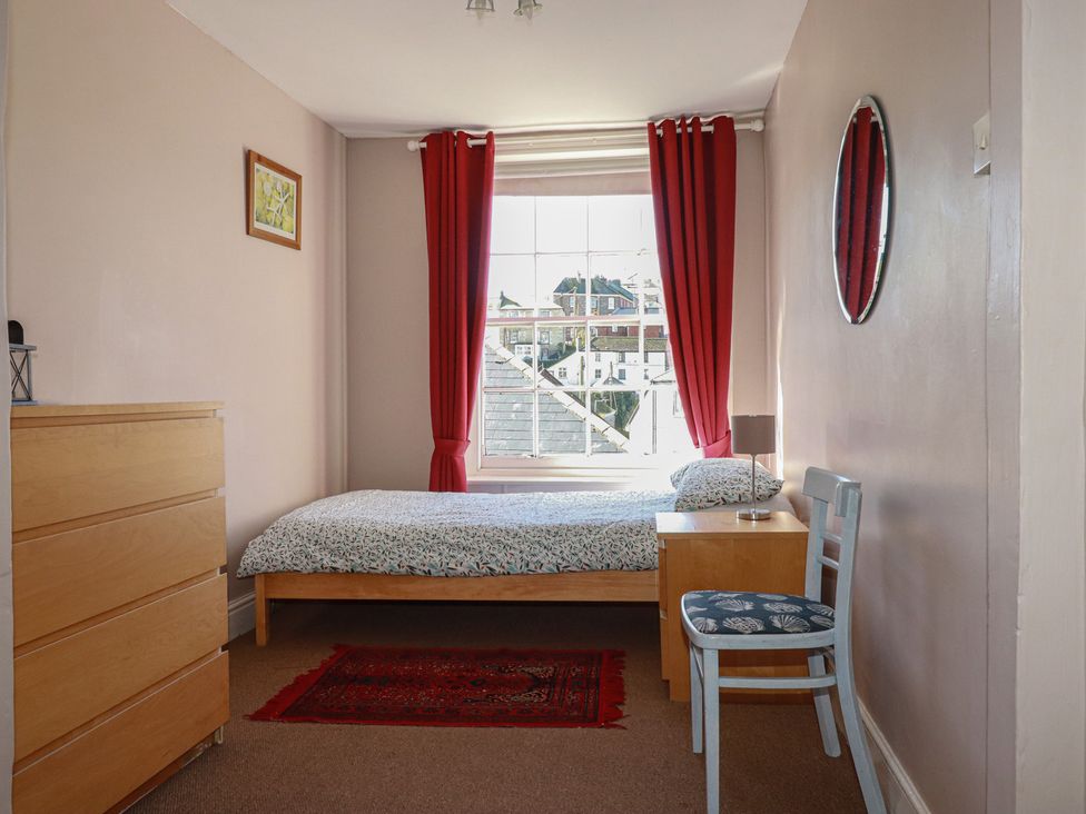 A bedroom with a bed and furniture at The Old Bank House in Mevagissey