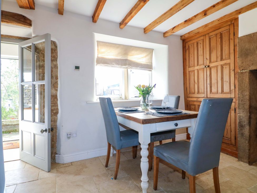 A dining room with a table and chairs at 2 Knoll Mount in Matlock