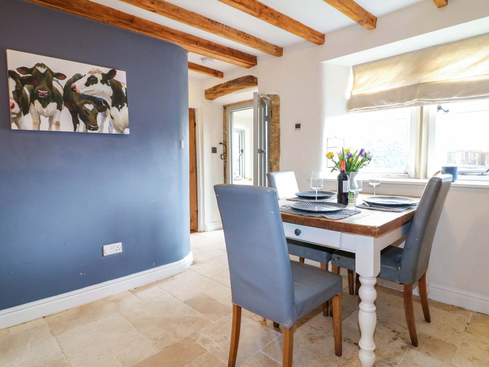 A dining room with a table and chairs at 2 Knoll Mount in Matlock