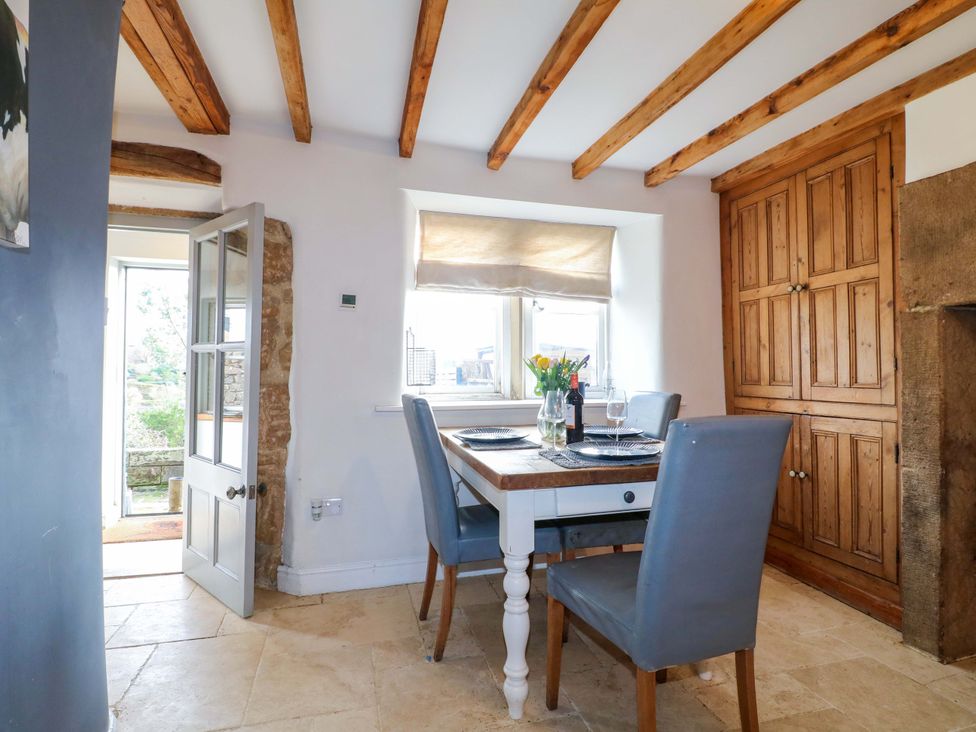 A dining room with a table and chairs at 2 Knoll Mount in Matlock