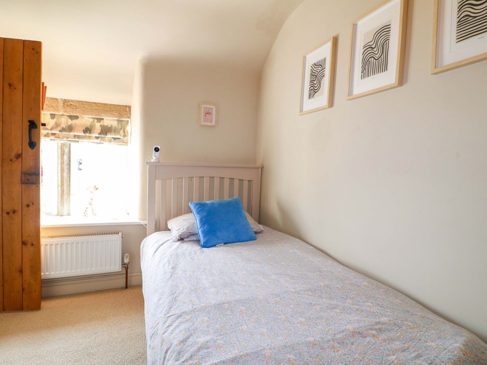 A bedroom with a single bed and window at 2 Knoll Mount in Matlock