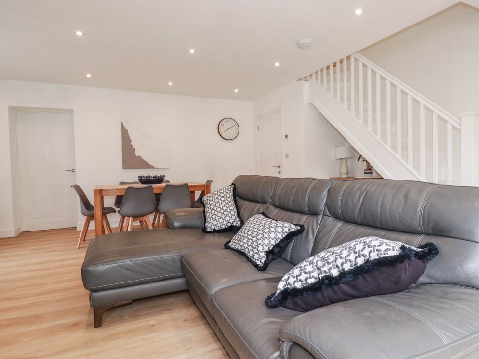 A living room with a sofa and dining area at Creek Lodge in Chacewater