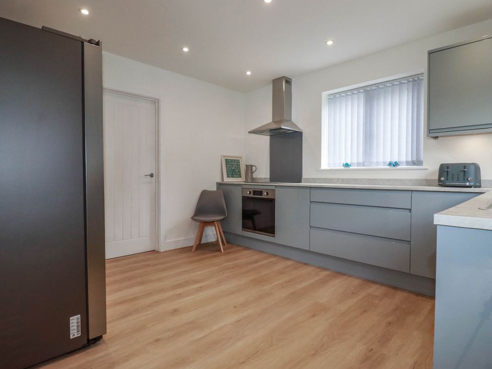 A kitchen with appliances and a window at Creek Lodge in Chacewater