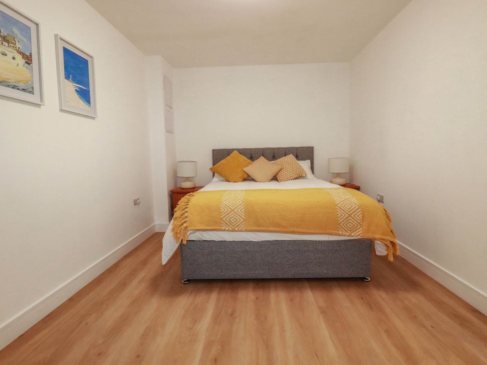 A bedroom with a bed and nightstands at Creek Lodge in Chacewater