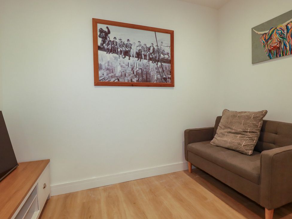 A living room with a sofa and wall art at Creek Lodge in Chacewater