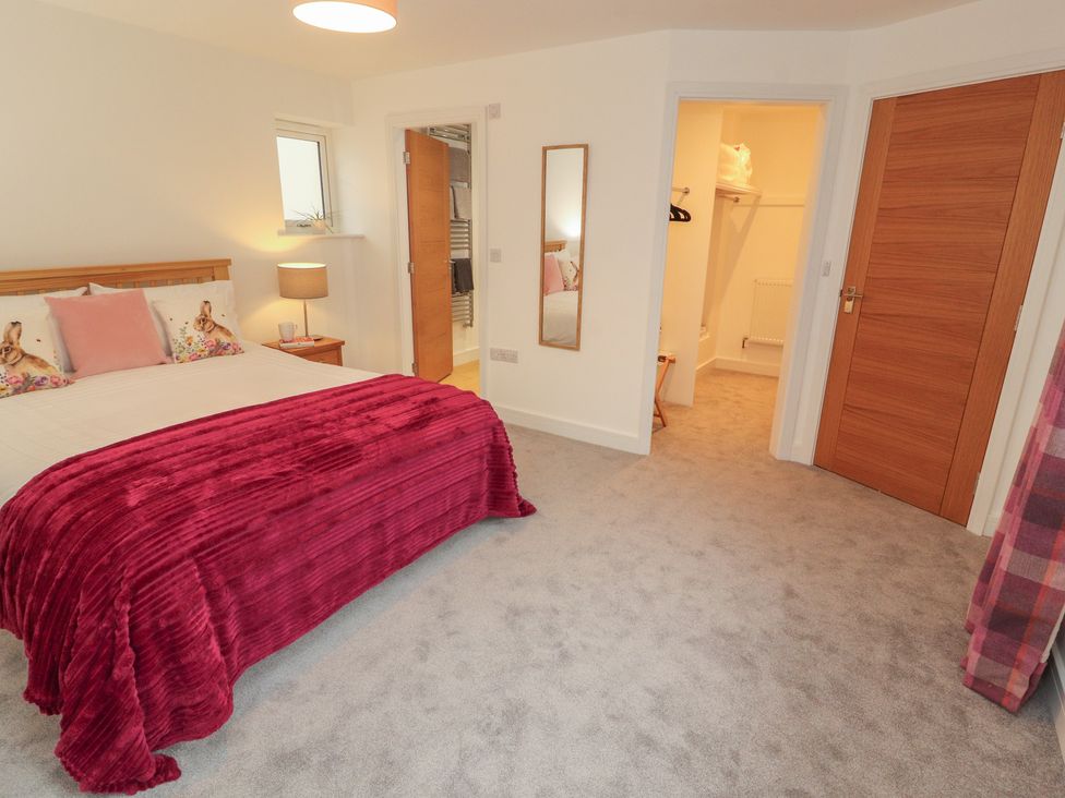 A bedroom with a bed and lamp at Little Plum Tree in Milnthorpe