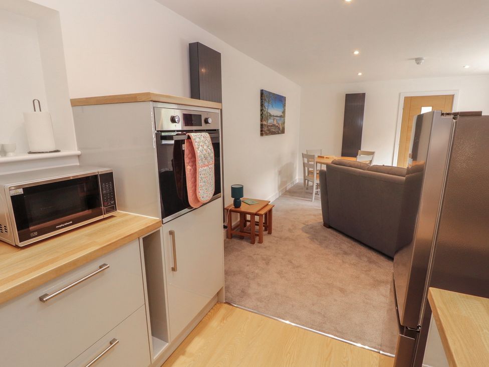 A kitchen with microwave and oven at Little Plumtree in Milnthorpe