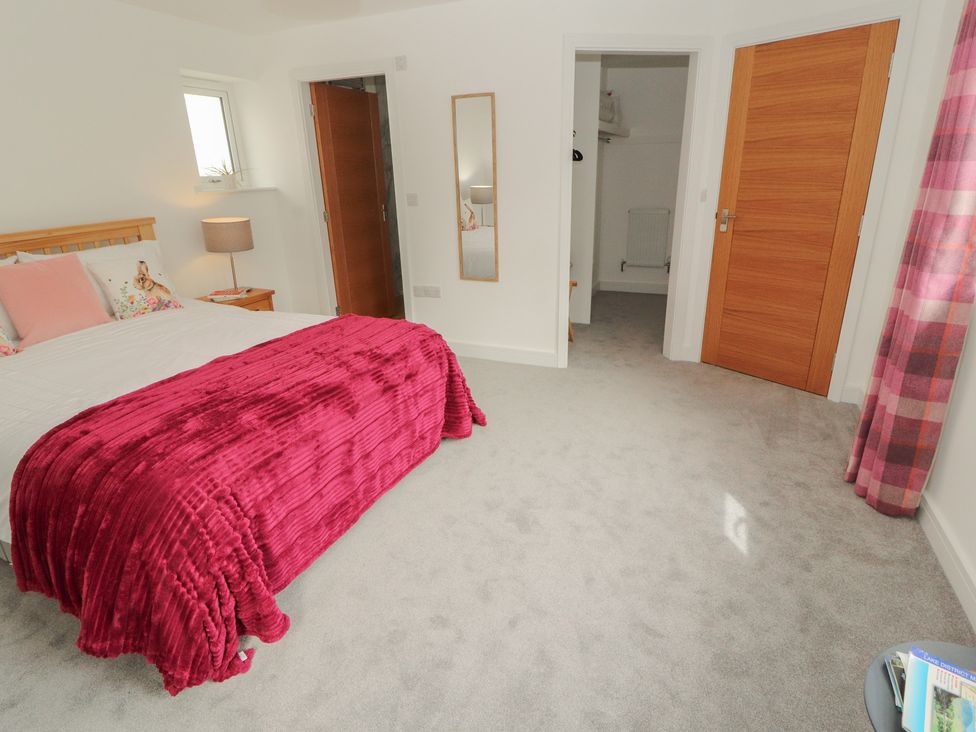 A bedroom with a bed and a nightstand at Little Plumtree in Milnthorpe