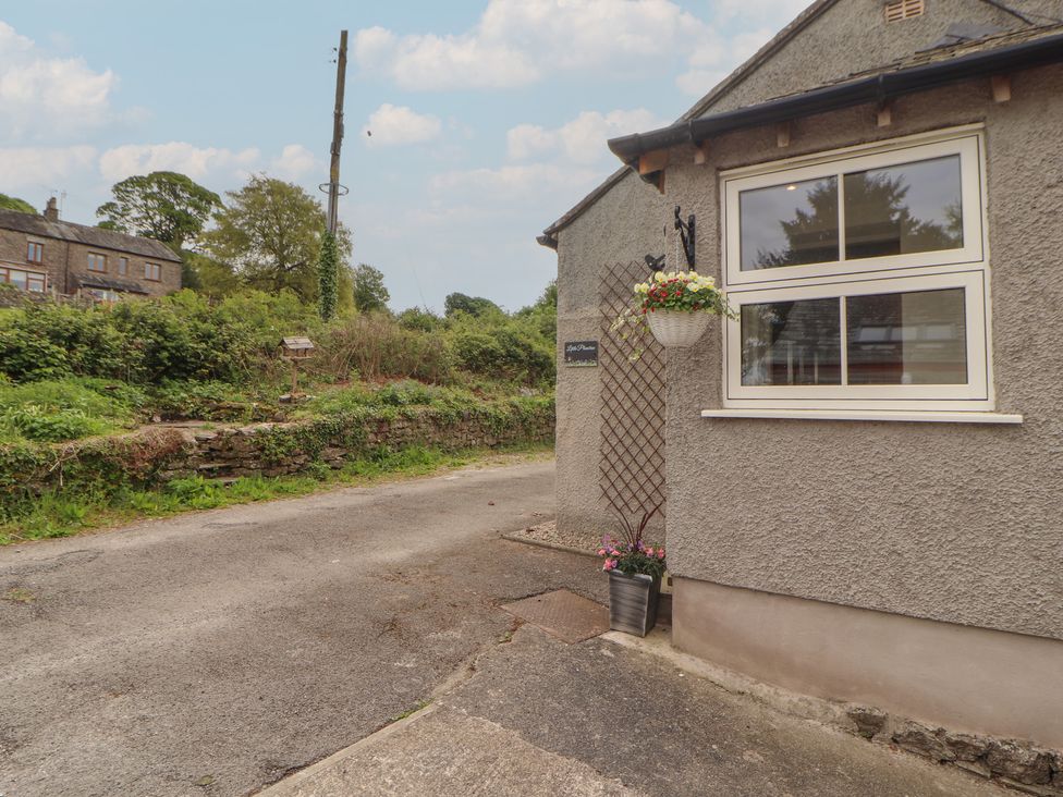 An outdoor view of a house with a pathway at Little Plumtree in Milnthorpe