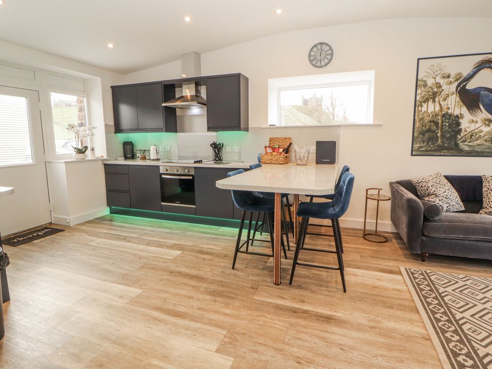 A kitchen with black cabinets and countertop at Blue heron lodge Kirkby Stephen