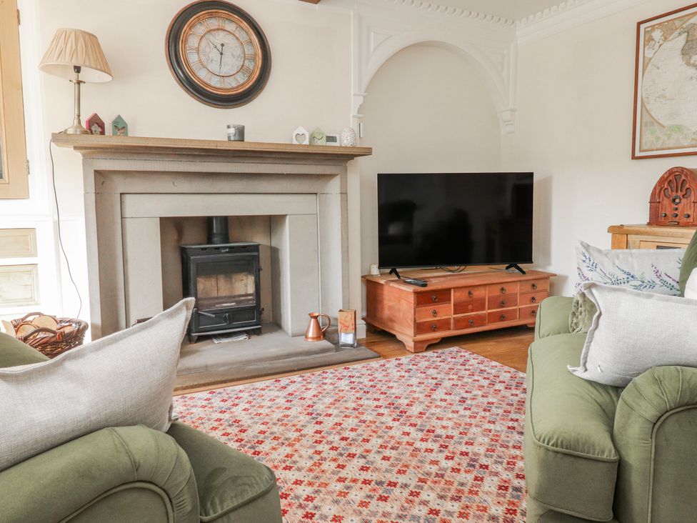 A living room with a fireplace and a television at Vasey Croft Stanbury near Haworth