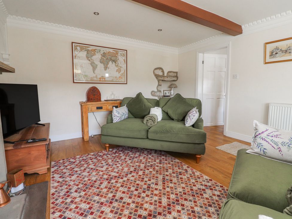 A living room with a sofa and television at Vasey Croft in Stanbury near Haworth