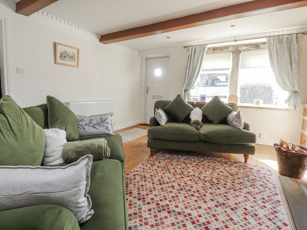 A living room with two sofas and a window at Vasey Croft in Stanbury near Haworth