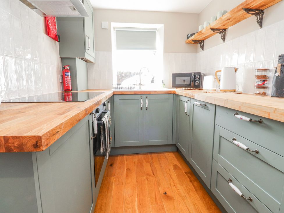A kitchen with a sink and microwave at Vasey Croft in Stanbury near Haworth