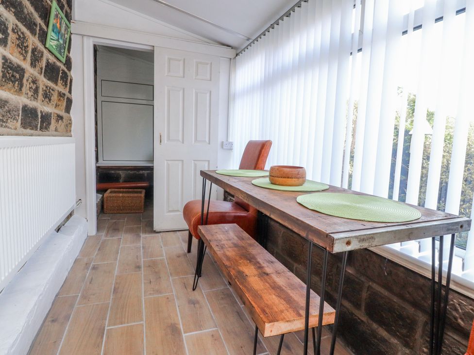 A dining area with a table and chairs at Vasey Croft in Stanbury near Haworth