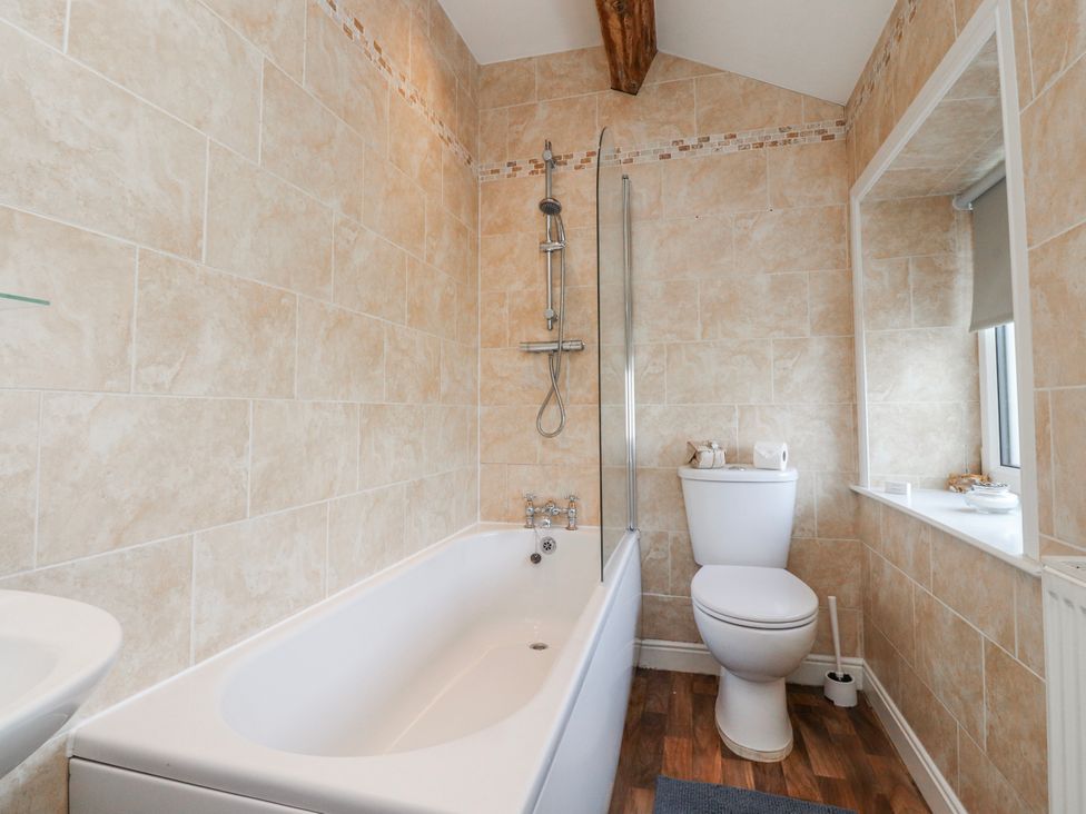 A bathroom with a bathtub and shower at Vasey Croft Stanbury near Haworth