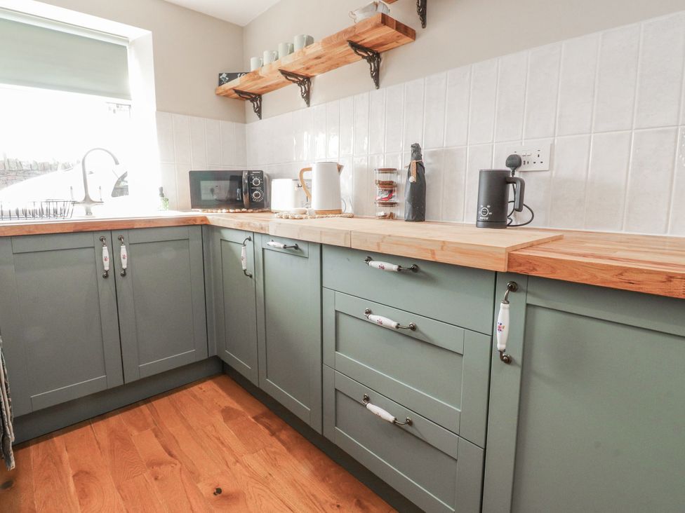 A kitchen with cabinets and appliances at Vasey Croft in Stanbury near Haworth
