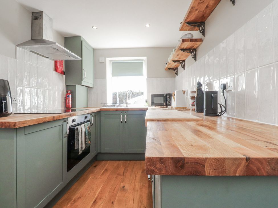 A kitchen with cabinets, shelves, and appliances at Vasey Croft in Stanbury near Haworth