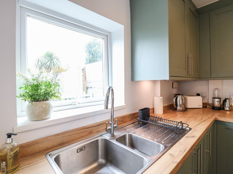 A kitchen with a sink and window at Meregate Cottage, Margate