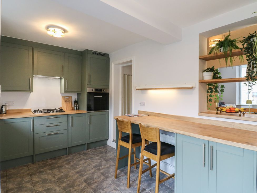 A kitchen with cabinets and countertop at Meregate Cottage in Margate