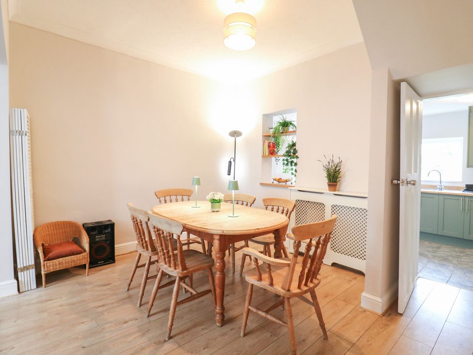 A dining room with a table and chairs at Meregate Cottage in Margate