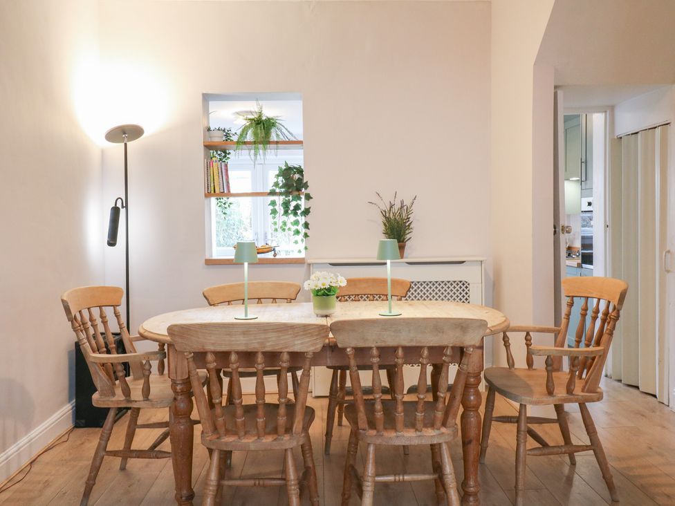 A dining room with a table and chairs at Meregate Cottage in Margate