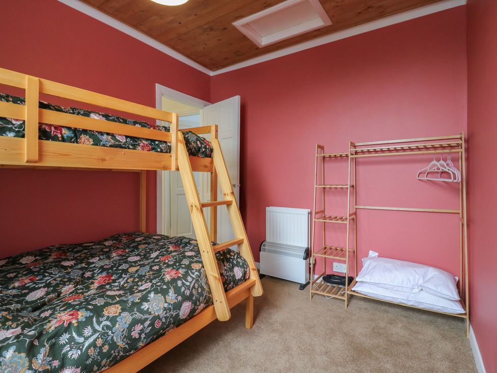 A bedroom with a bunk bed and shelves at Meregate Cottage in Margate